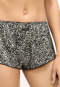 Boxers imprimés léopard dans une teinte beige clair et noire. Dotés d'une taille élastique et d'une étiquette de logo Calvin Klein. Texture douce.