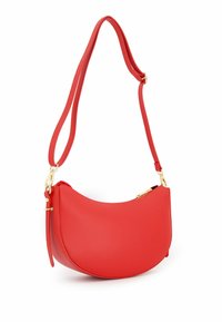 Red leather handbag with a curved shape, adjustable strap, and gold-tone hardware. Features a zip closure and smooth texture.