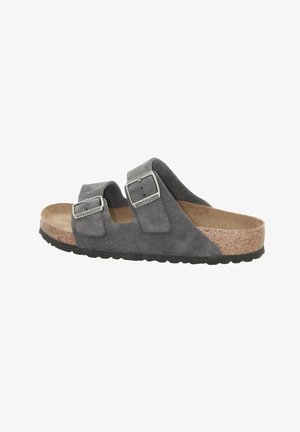 Gray suede sandal with dual adjustable straps, silver buckles, cork footbed, and textured rubber sole, designed for comfort and durability.