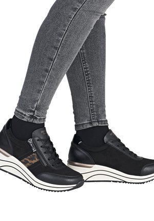 Zwarte schoenen met een mix van matte en glanzende materialen, voorzien van een ritsluiting, gestreepte zool en een luipaardprintaccent aan de zijkant.