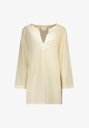 Tunique crème à manches longues avec col en V et broderie florale autour du col et des poignets.