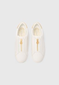 White slip-on sneakers with gold zippers and gold heel accents, Michael Kors logo on zipper pull and inside sole.
