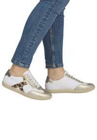 White sneakers with gold accents, featuring a leopard print detail and a side zipper. Rubber sole and lace-up front.