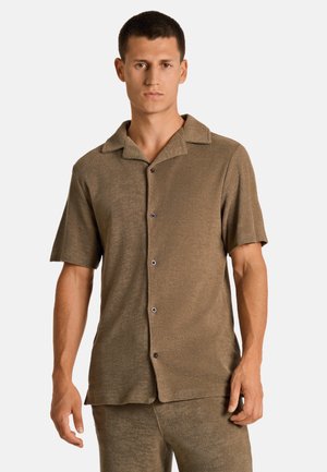 Chemise à manches courtes en tissu texturé marron, dotée d'un col et de cinq boutons sur le devant. Fini lisse avec une coupe décontractée et un léger éclat.