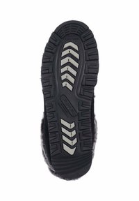 Schwarze Sohle mit strukturiertem Grip-Muster und gezackten Kanten. Weiches, flauschiges Obermaterial ist entlang des Randes sichtbar.