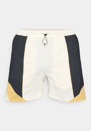 Men's swim shorts featuring a combination of cream, navy, and yellow colors, with a mesh pattern on the sides and an elastic waistband with drawstring.