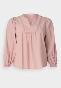 Blusa rosa chiaro con scollatura a V, fronte arricciato e maniche lunghe a sbuffo con polsini elasticizzati. Tessuto texturizzato con sottili linee verticali.