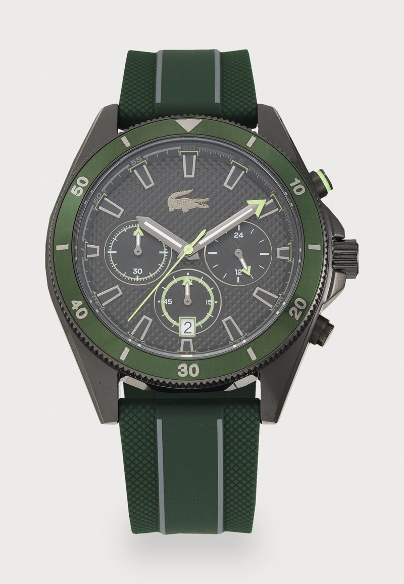 Green rubber strap watch with black and green case, textured dial, silver hands, and three sub-dials. Features a date window at the bottom.