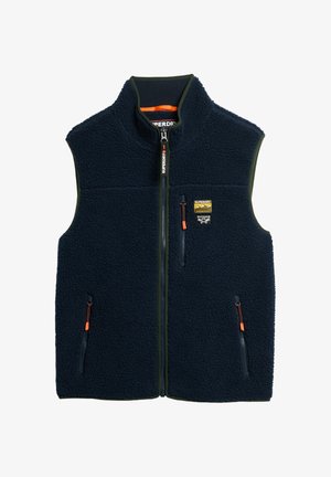 Navy blue fleece vest with front zipper, three zippered pockets with orange pulls, and a small Superdry Outdoor Co patch on chest.