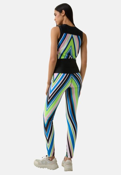 Colorful athletic outfit featuring a sleeveless top and fitted leggings with a zigzag pattern in shades of green, blue, pink, and black.