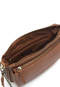 Brown leather crossbody bag with a zip closure, interior compartments, and a chain strap. Soft texture with a matte finish.