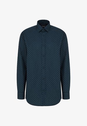 Koszula z długim rękawem zapinana na guziki w ciemnogranatowym kolorze z białymi kropkami, z klasycznym kołnierzykiem i zaokrąglonym dołem. Wykonana z lekkiego materiału.