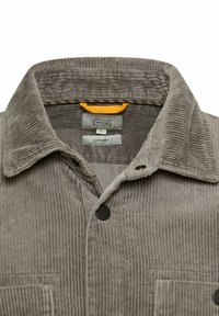 Grijze corduroy overshirt met zwarte drukknoopsluitingen, spread collar en twee borstzakken, gelabeld Camel Active, maat L.