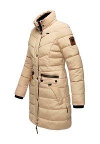 Beige puffer coat with a high collar, insulated design, zippered and buttoned front, side pockets, and black ribbed cuffs.