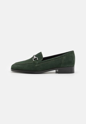 Green suede loafers with a low block heel, featuring a silver-tone buckle accent and contrasting stitching details. Smooth texture.