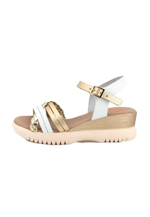 Sandalia de cuña para mujer con suela beige, tiras metálicas doradas y blancas, que incluyen detalles trenzados y hebilla en la correa del tobillo.
