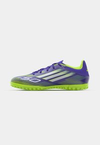 Purple and lime green soccer shoes with a textured design, featuring a lightweight upper, lace closure, and rubber outsole for traction.