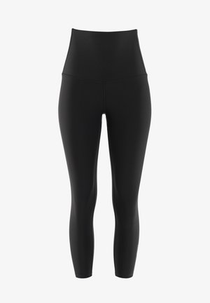 Hochtaillierte schwarze Leggings aus dehnbarem Stoff. Sie verfügen über eine glatte Textur, eine enganliegende Passform und keine sichtbaren Befestigungen oder Muster.