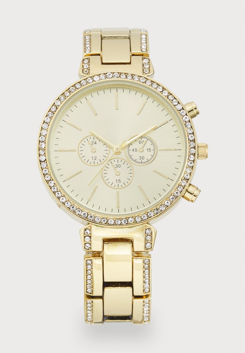 Gold chronograph watch with a round face. Features a cream dial, three sub-dials, and a bezel embellished with clear stones. Metal band links.