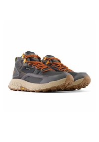 Grey hiking shoes with orange laces and accents; textured rubber sole; padded collar and tongue; waterproof material; reinforced toe.