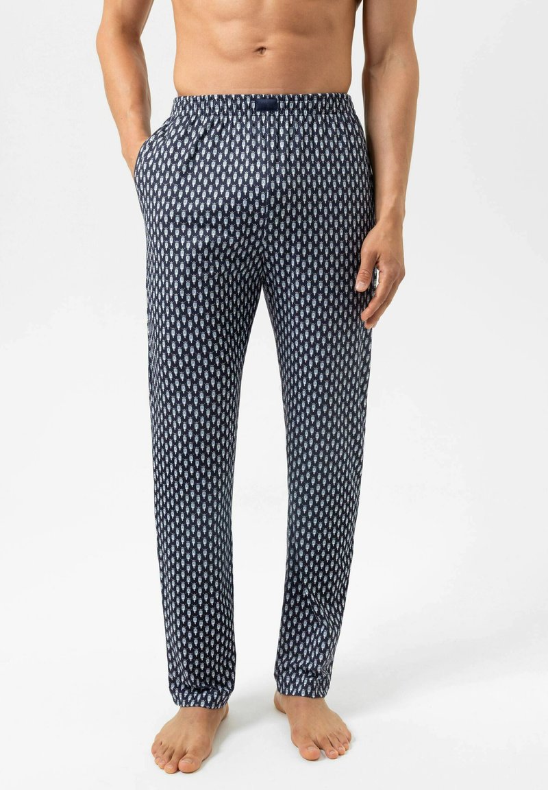 Marineblauwe pyjamabroek met een geometrisch wit patroon, een elastische tailleband, zijzakken en omgebouwde zoom. Zachte stoftextuur.