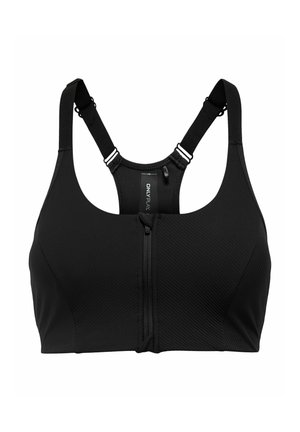 Brassière de sport noire avec fermeture éclair frontale, larges bretelles réglables, et design dos nageur, présentant une texture côtelée subtile et une étiquette de marque à l'intérieur.