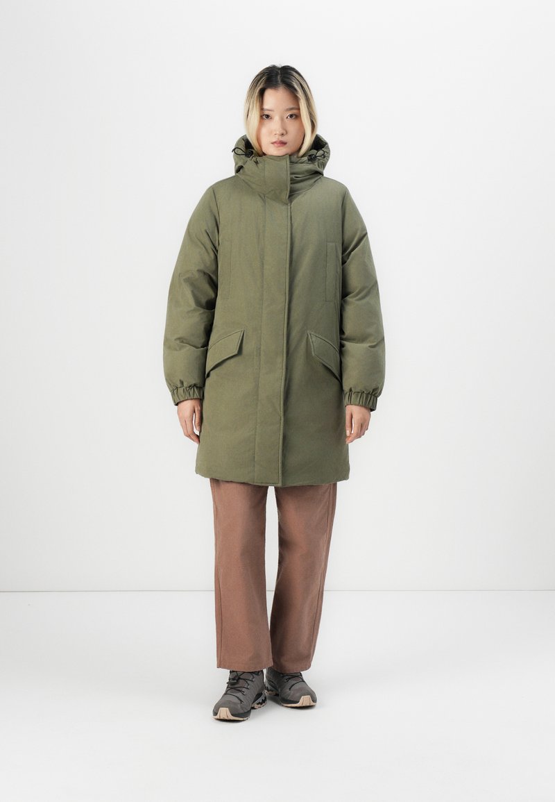 Olive green puffer coat with a high collar, elastic cuffs, and two front pockets, worn over brown wide-leg pants and gray shoes.