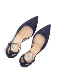 Navy blue suede pointed-toe flats with ankle strap, featuring a smooth interior, cut-out sides, and a light beige insole. Brand label visible.