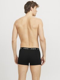 Schwarze Boxershorts aus weichem Material mit elastischem Bund und weißem Logo. Entworfen für Komfort und Passform, zeigen sie eine enganliegende Silhouette.