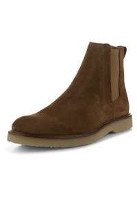 Brun mockasins Chelsea med elastiska sidopaneler och en texturerad gummisula. Har en slät, rund tå och minimala sömnadsdetaljer.