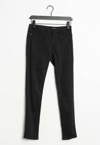 Leggings noirs avec une taille élastique, fabriqués dans un tissu lisse et extensible. Présentent une coupe slim et un design minimal sans embellissements.