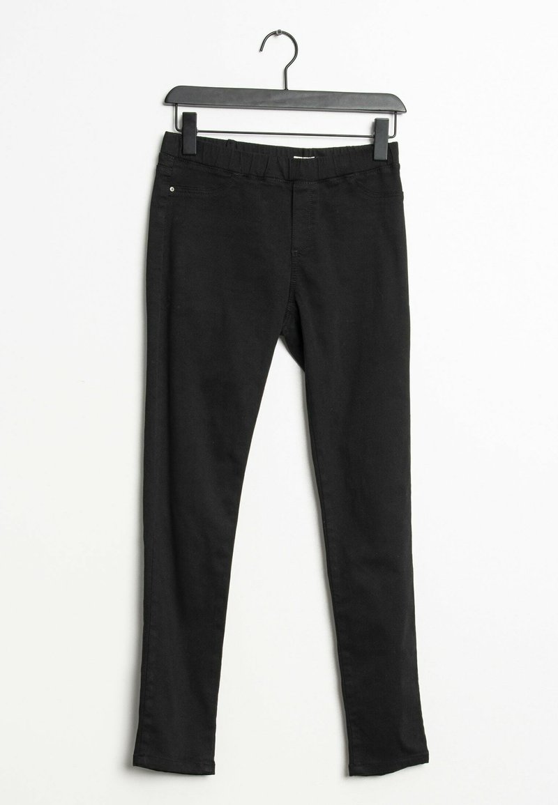 Leggings noirs avec une taille élastique, fabriqués dans un tissu lisse et extensible. Présentent une coupe slim et un design minimal sans embellissements.