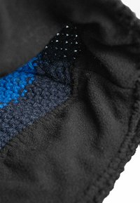 Knitted hat with a black fleece interior, featuring blue and dark knit textures. Seam edges are neatly finished, providing a snug fit.