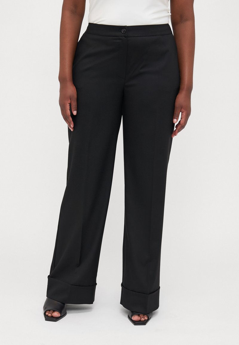 Black trousers with a tailored fit, wide legs, and a flat waistband. Features a button closure and turned-up cuffs. Smooth texture.