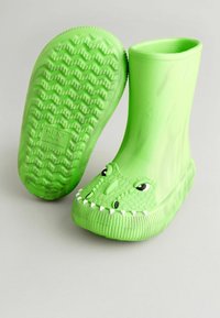 Bottes de pluie en caoutchouc vert avec un design de visage de dinosaure, écailles texturées, corps large et semelle à motifs. Convient aux conditions humides.