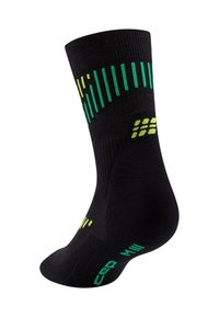 Schwarze Socke mit grünen Akzenten und vertikalen Streifenmustern. Das Material erscheint strukturiert; enthält eine Markenkennzeichnung in der Nähe der Zehen- und Fußgewölbebereiche.