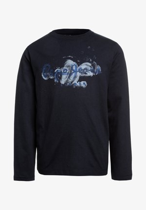Sort langærmet rundhals trøje med blå og hvid abstrakt design og delvist læselig tekst tværs over brystet.
