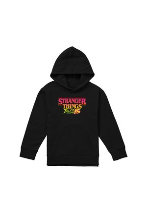Black hoodie with front pocket and "Stranger Things Tales from 85" text in red, orange, and yellow on the chest.