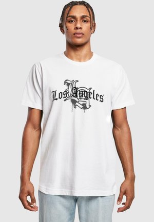 White cotton t-shirt featuring a black graphic design with the text "Los Angeles" in a stylized font, short sleeves, and a crew neck.