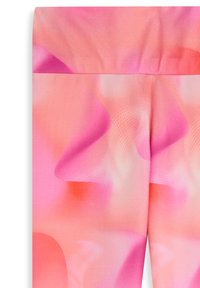 Leggings en una tela suave y ligera con un patrón degradado de tonos rosados suaves, con formas fluidas y sutiles detalles de puntos.