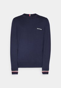 Maglione a maniche lunghe blu navy realizzato in morbido materiale, con un piccolo logo bianco sul petto e polsini striati in rosso, bianco e blu.