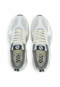 Scarpe sportive grigio chiaro con pannelli in rete, suole spesse e lacci. Caratteristiche notevoli includono un logo sul tallone e un'etichetta a scacchi.