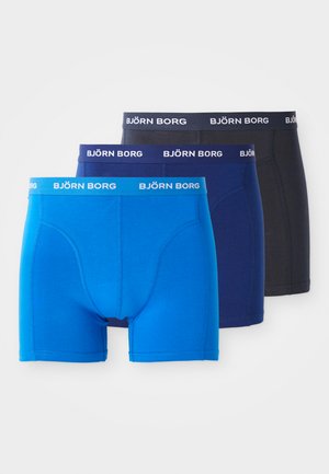 Three pairs of snug-fitting boxers in bright blue, dark blue, and black, featuring elastic waistbands with the "BJÖRN BORG" logo.