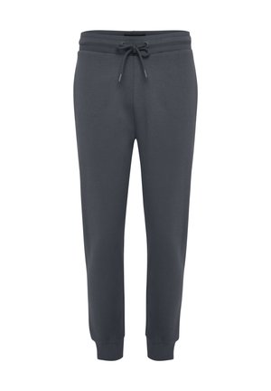 Ciemnoszare spodnie dresowe z miękkiego materiału; zwężany fason z elastycznym pasem i sznurkiem do regulacji; ściągacze na nogawkach przy kostkach. Brak kieszeni.