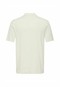 Polo à manches courtes uni de couleur ivoire, vu de dos, avec un col et un ourlet droit.