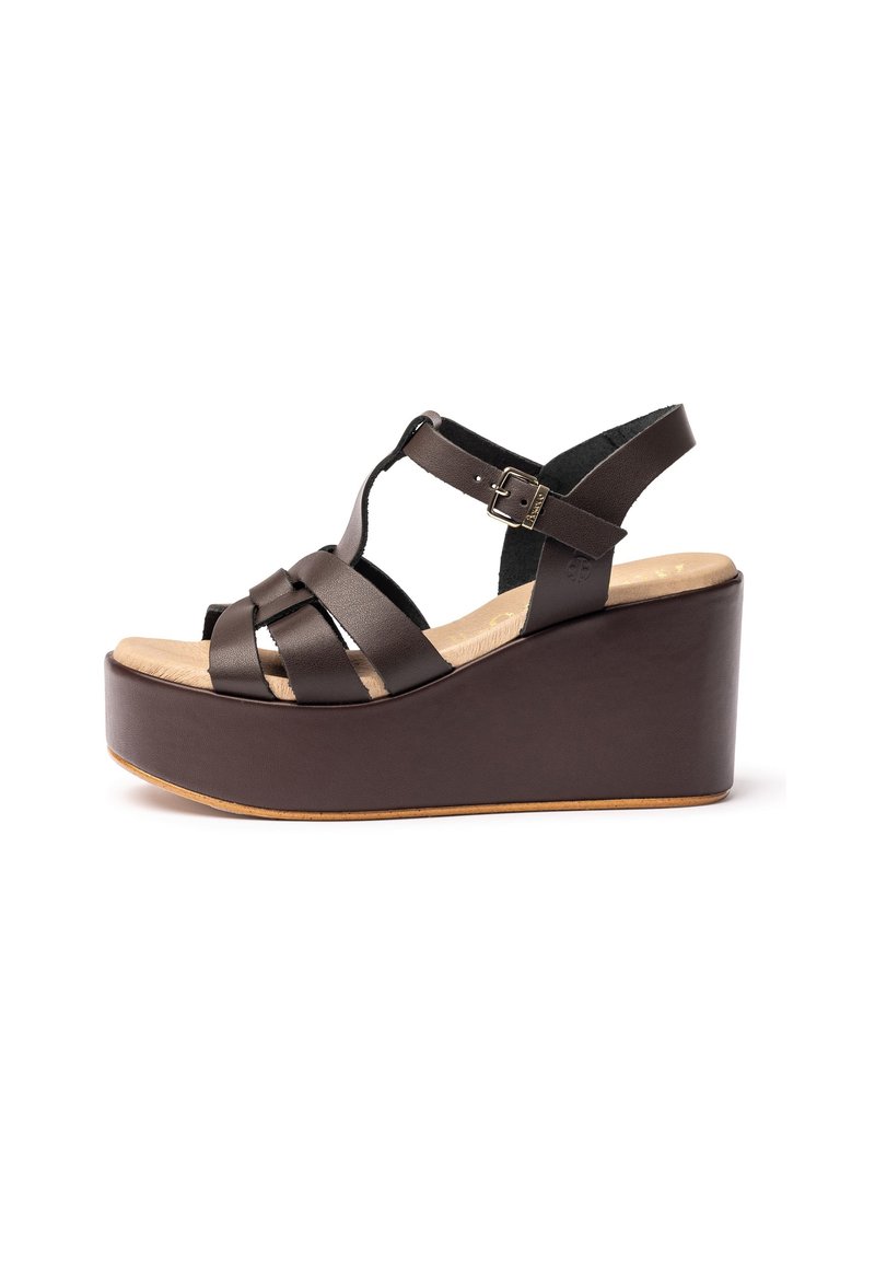 Brown leather wedge sandals with a platform sole, featuring crisscross straps and an adjustable buckle for secure fit.