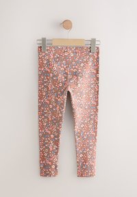 Blomstrede leggings i brunt stof med mønstre af pink, blå og hvide blomster. Mellem talje design med slank pasform uden synligt hardware.