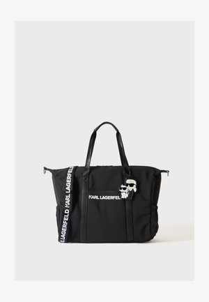 Sort Karl Lagerfeld tote taske med lange håndtag, med hvidt brandet tekst og tegneseriefigur-nøglering fastgjort foran.