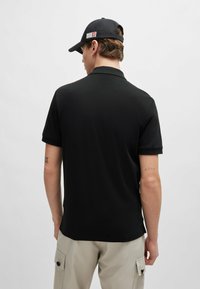 HUGO DALOMINO - Polo - black one