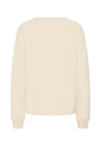 Sweat-shirt beige à manches longues avec encolure ronde et poignets côtelés, montré de dos sur un fond blanc uni.